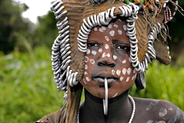 A child with traditional face paint on.