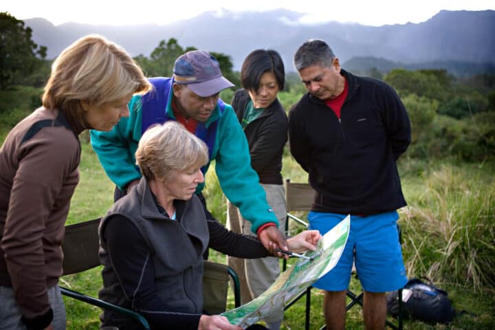 A group of travelers examining a map together.