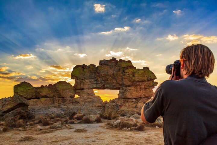 A photographer taking a photo of rocks in Madagascar.