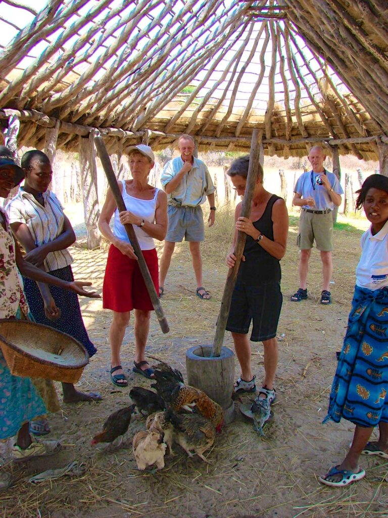 Travelers interacting with villagers in Zimbabwe.