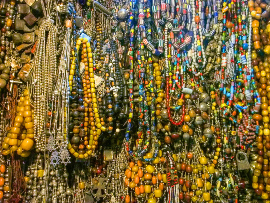An assortment of colorful Ethiopian beaded necklaces hanging closely together.