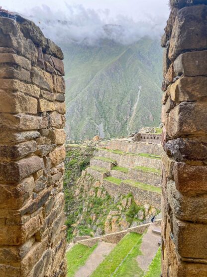 Discovering ancient stone walls reveals terraced landscapes and mountains shrouded in mist, evoking the mystique of Peru's Sacred Valley.